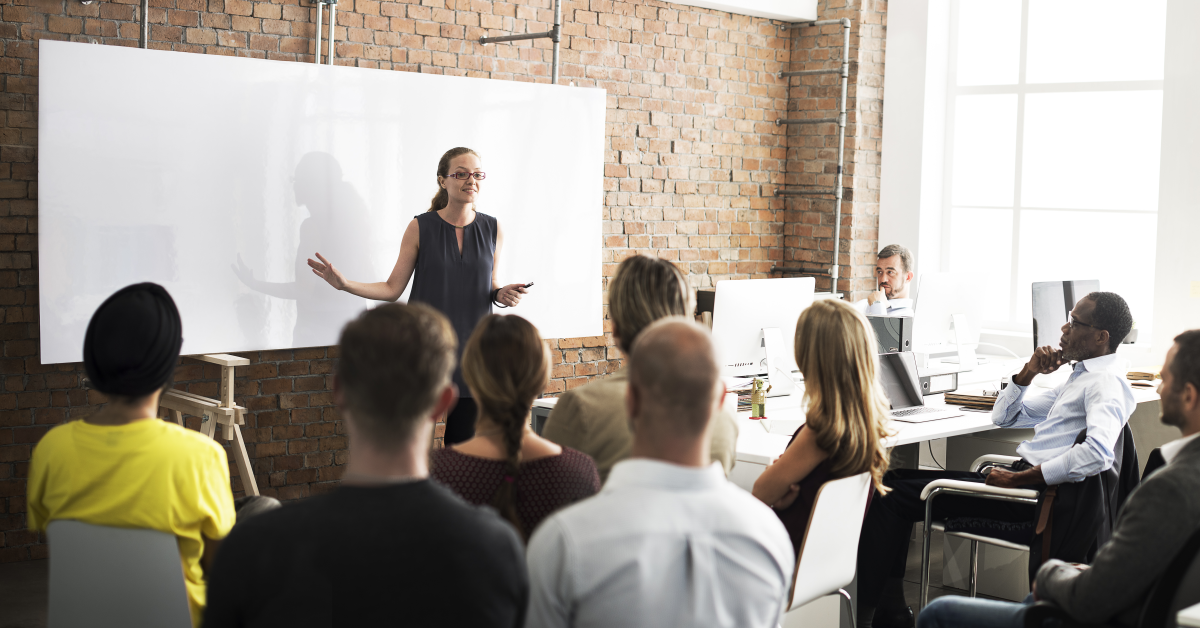 young female teacher talking to young colleagues